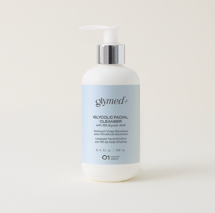 White pump bottle with light blue label of Glymed Plus glycolic facial cleanser. Clear, minimal design on a plain background conveys a fresh, clean feeling.