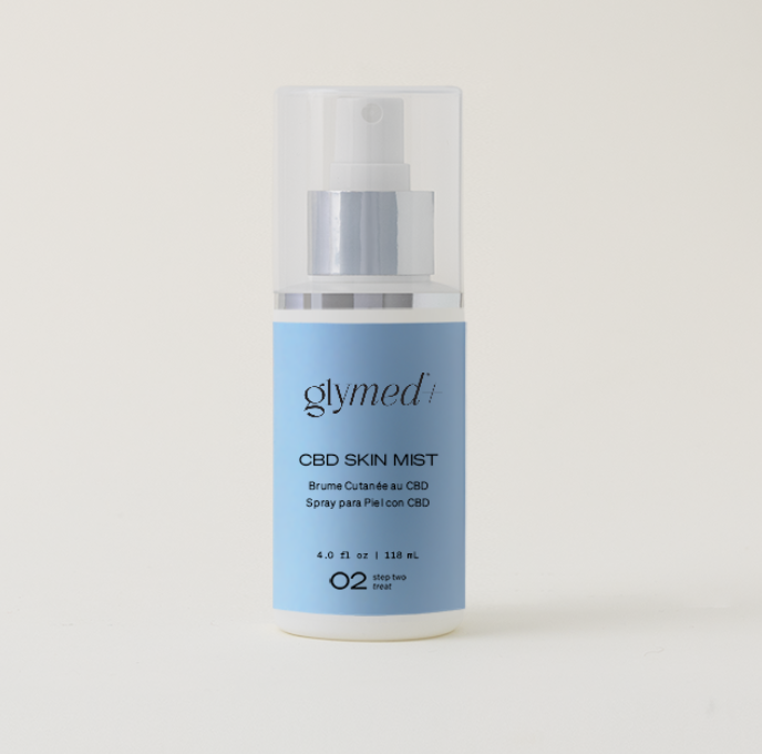 A light blue bottle of Glymed Plus CBD Skin Mist with a clear cap, featuring simple, modern design. Text includes product details and size; conveys elegance.