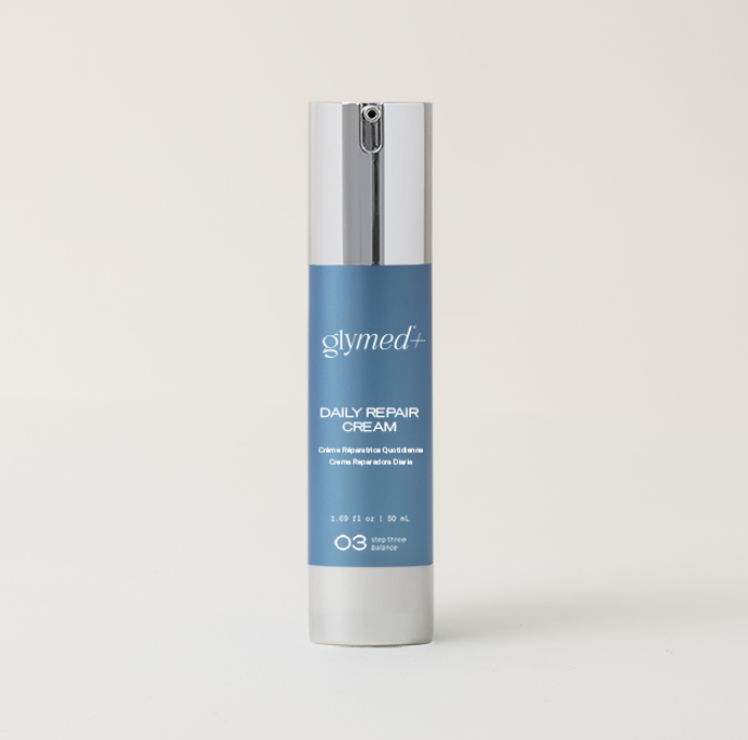 A sleek blue bottle of Glymed Plus Daily Repair Cream with silver accents, standing against a light background, conveying elegance and premium skincare.