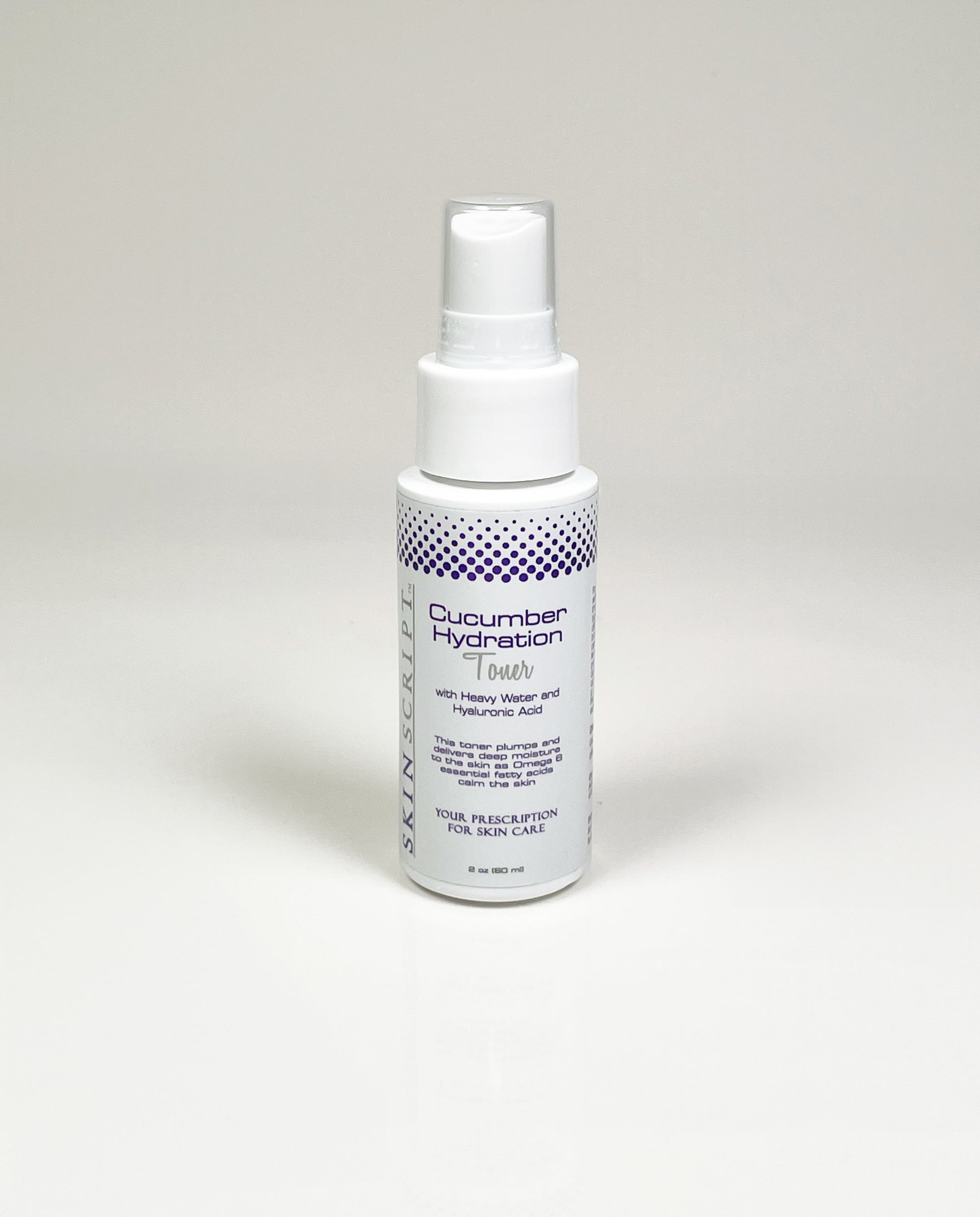 A white spray bottle labeled “Cucumber Hydration Toner” stands on a plain surface. Minimalist design with blue dots, conveying freshness and simplicity.